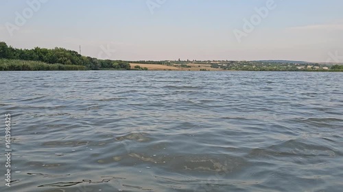A body of water with land in the background