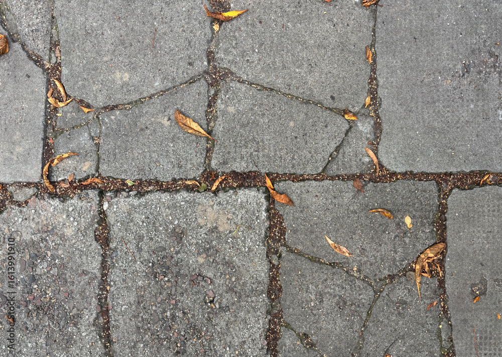 Obraz premium Old cobblestone road, vintage cracked pavement with rough textured stones
