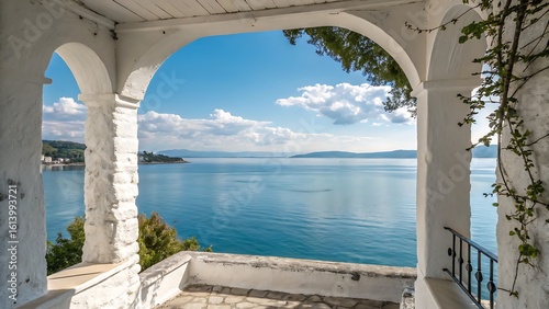 Serene Coastal View Through White Arches: Azure Sea, Distant Mountains, and Lush Greenery Creates a Tranquil Escape.