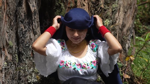 Indigenous woman adjusting her traditional headscarf in slow motion