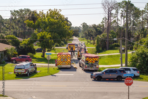 First responders investigating fire hazard of private house. Emergency service personnel responding to carbon monoxide accident on Florida residential street