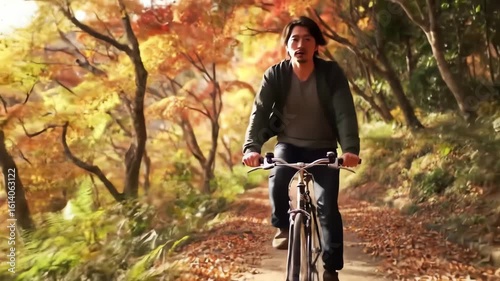 A man riding his bicycle along a scenic forest trail surrounded by beautiful autumn foliage