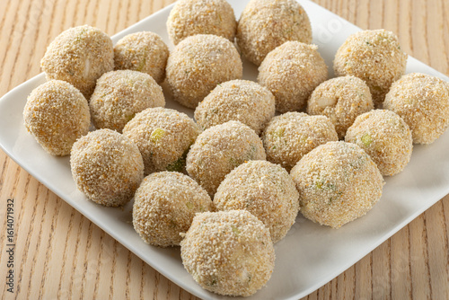 Tableau sur toile Crispy tuna potato croquettes with breadcrumb coating on white plate