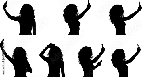 Silhouette of a woman taking a selfie with her smartphone, capturing modern digital culture and self-expression.
