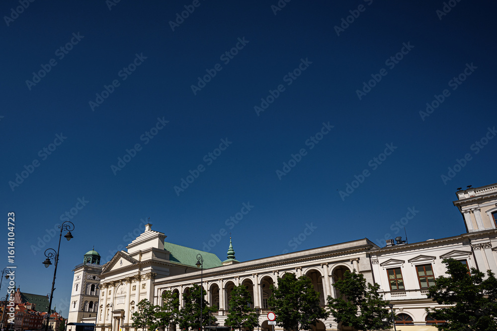 Obraz premium Historic architecture and Krakowskie Przedmiescie street view in Warsaw, Poland under blue sky