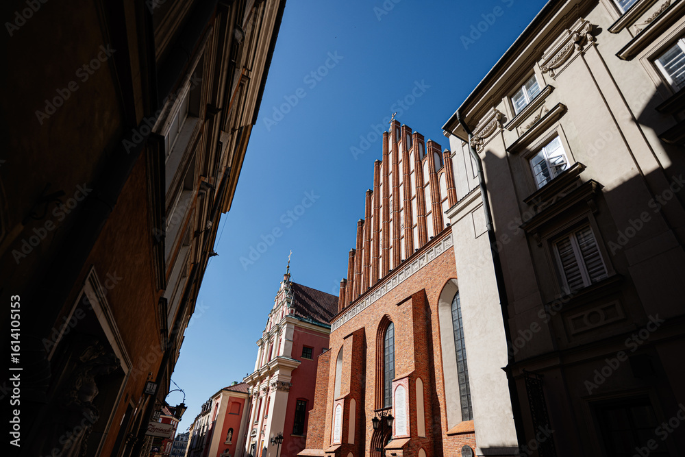 Fototapeta premium Historic St John's Archcathedral and old town street in Warsaw under blue sky