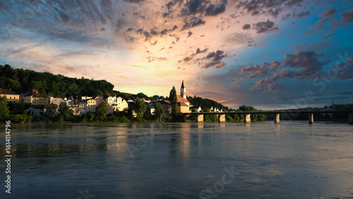 Beautiful Sunset with striking colors of homes and church building by the lake in Hallstatt Austria.