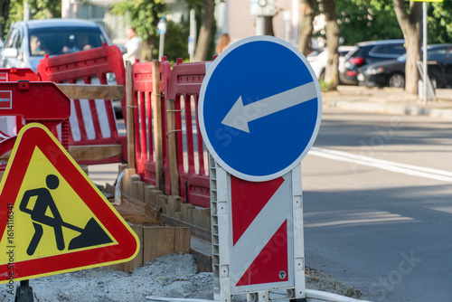 Quadro em tela Traffic signs indicating construction zone with directional guidance on a city s