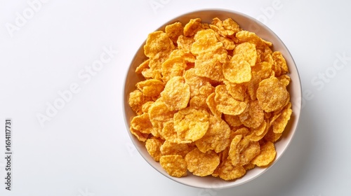 Top-down view of crunchy cornflakes served in a bowl on white background