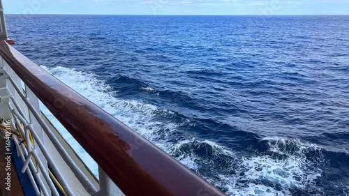Cruise ship railing with view of ocean water