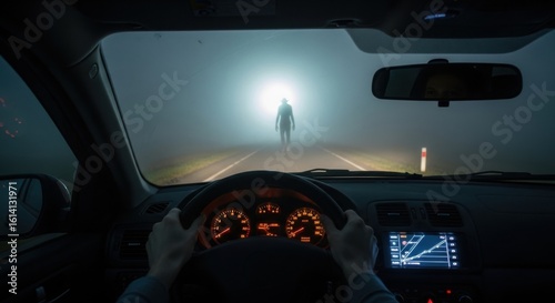 First-person view of a car driver on a foggy road with a mysterious monster figure ahead. Horror concept.