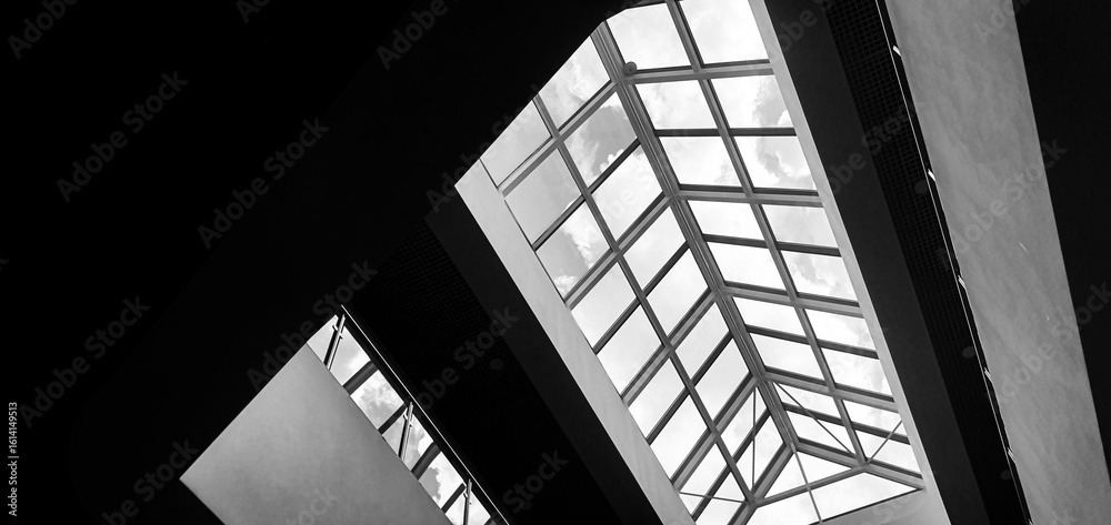 Obraz premium Transparent glass roof of the building. Architectural design of the roof of industrial premises, houses.
