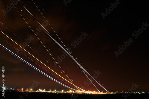 Multiple Airplanes Taking Off at Night with Long Exposure, Creating Multiple Light Trails