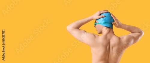 Male swimmer on yellow back...