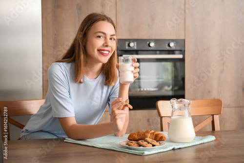 Young woman with glass of m...