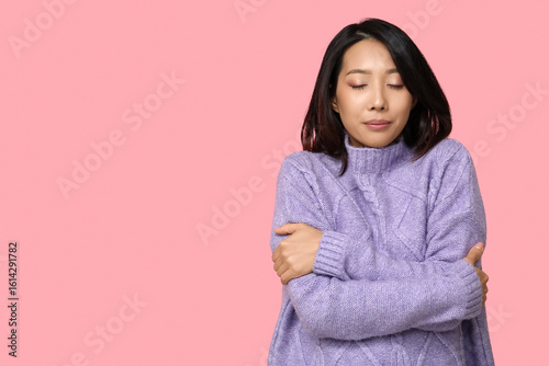 Young Asian woman hugging h...