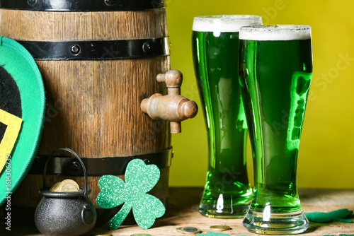 Glasses of green beer with ...