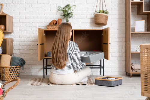 Young woman putting organiz...
