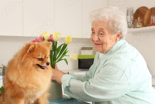 Senior woman with tulips an...