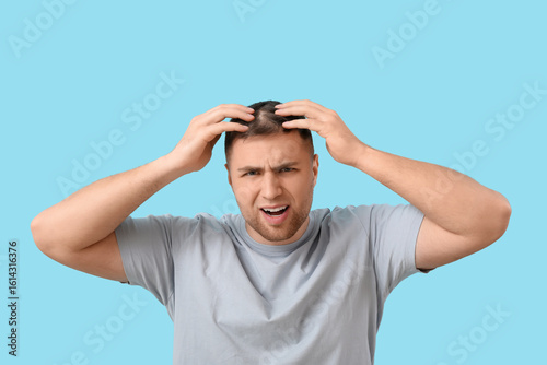 Worried young man with hair...