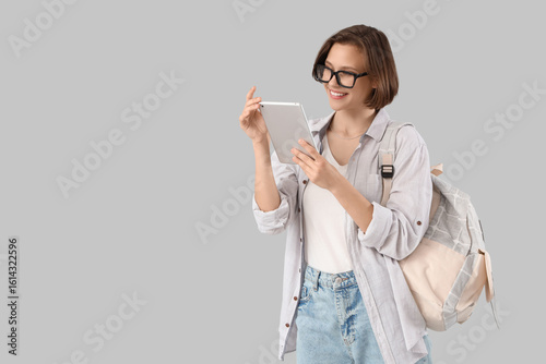 Happy female student with b...
