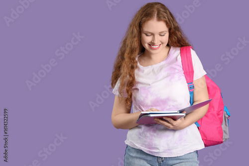 Happy female student with b...