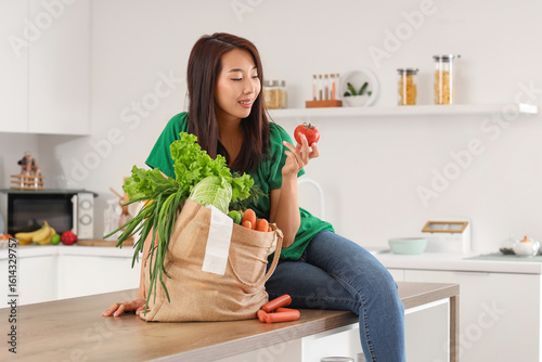 Young Asian woman with toma...