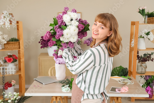 Female florist holding bouq...