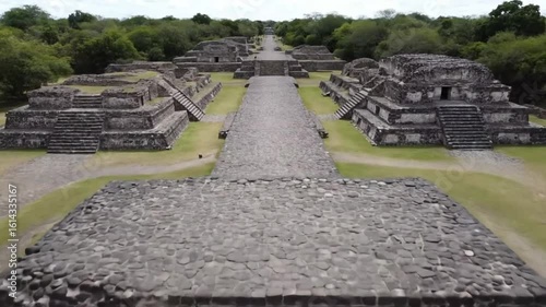 An aerial view captures the ancient pyramids and structures of an archaeological site, revealing the rich history and cultural heritage of a prehispanic civilization