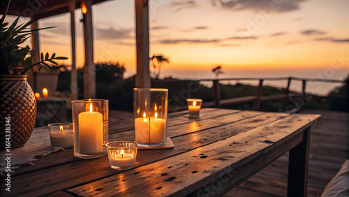 A serene outdoor setting with candles illuminating a wooden table at sunset, creating a romantic and tranquil atmosphere overlooking the sea, perfect for a relaxing evening or special celebration