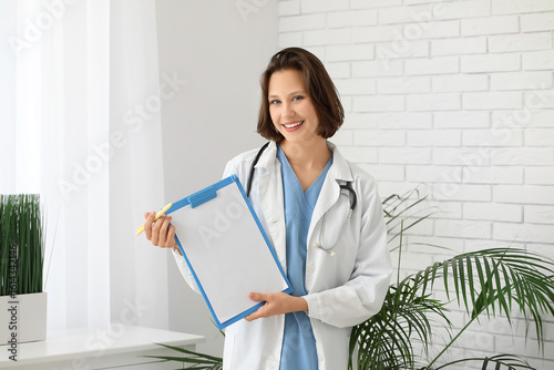 Happy female doctor with cl...