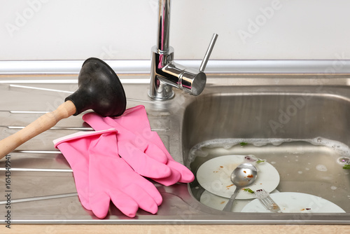 Metallic sink with soap wat...