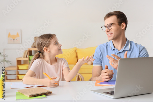 Teenage girl studying with ...