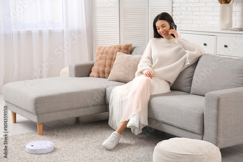 Young woman talking by mobi...