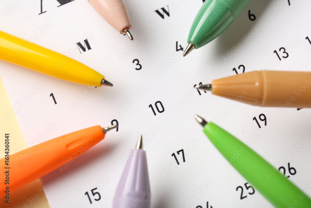 Fototapeta premium Calendar with colorful pens, closeup
