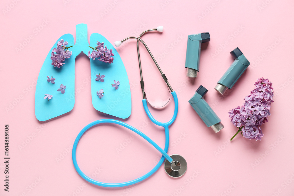 Fototapeta premium Asthma inhalers with stethoscope, paper lungs and lilac flowers on pink background