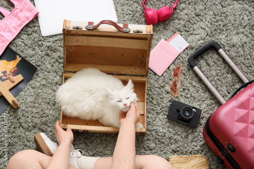 White cat in open suitcase ...
