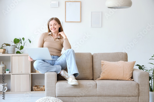 Young woman with laptop sit...