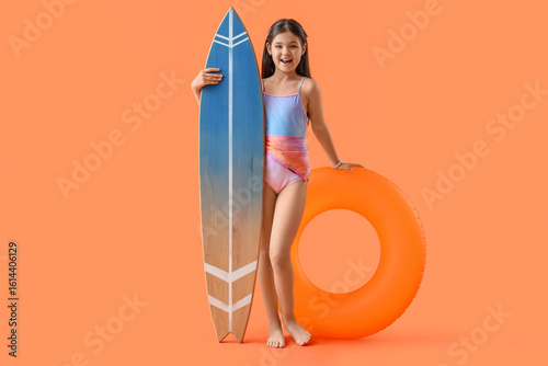 Cute girl with swim ring an...