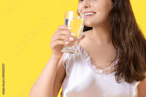 Young woman in pajamas drin...
