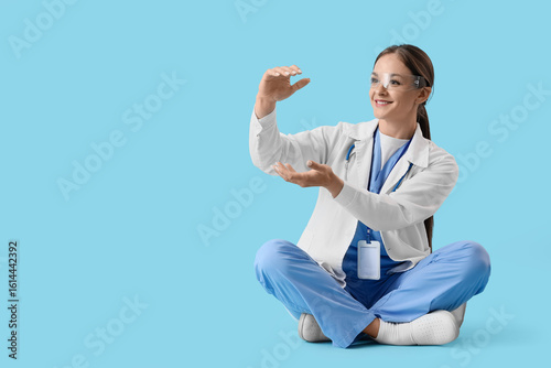 Female doctor in medical uniform and safety glasses interacting with virtual ...