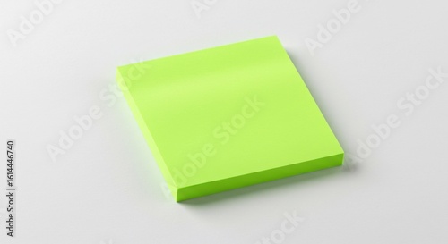 Bright lime-green sticky note on white surface