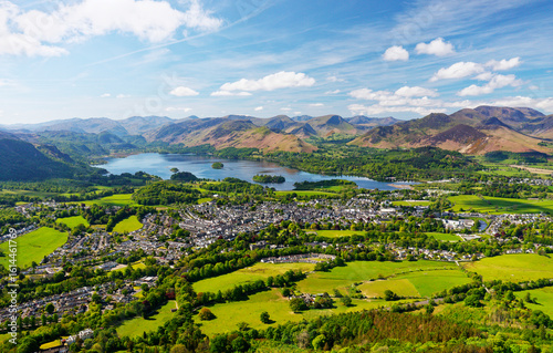 S.W. over Keswick town and Derwentwater to Cat Bells and Newlands in the Lake District. Rust winter bracken still covers fells in May. Early morning