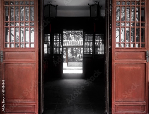 Symmetrical Chinese antique doors lead to the corridor