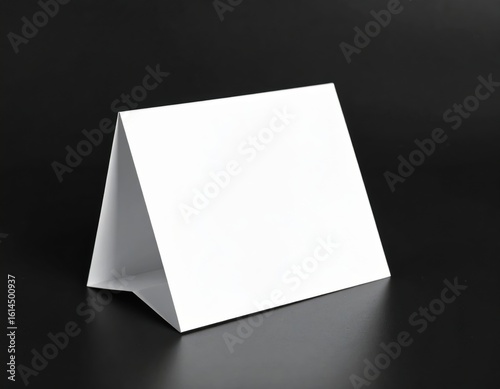 Blank white table tent card displayed on a dark surface