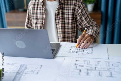 Tableau sur toile Architectural Drawing of Building Project with Colleagues Designing Blueprint Us