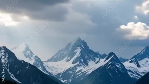 Time-lapse of Clouds Moving Over Snowy Mountain Peaks with Light Rays