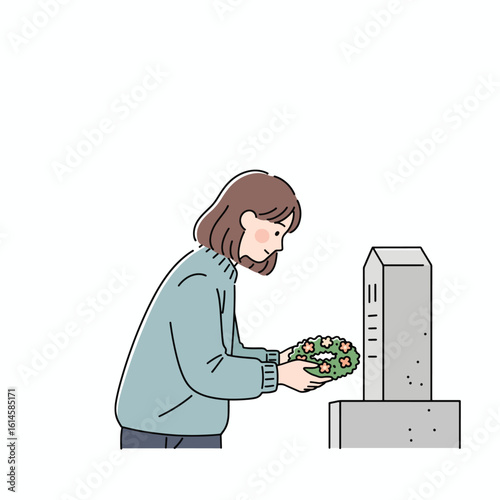A woman places a wreath at a gravestone in remembrance.