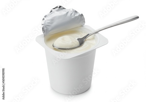Open yogurt cup with spoon isolated on white background