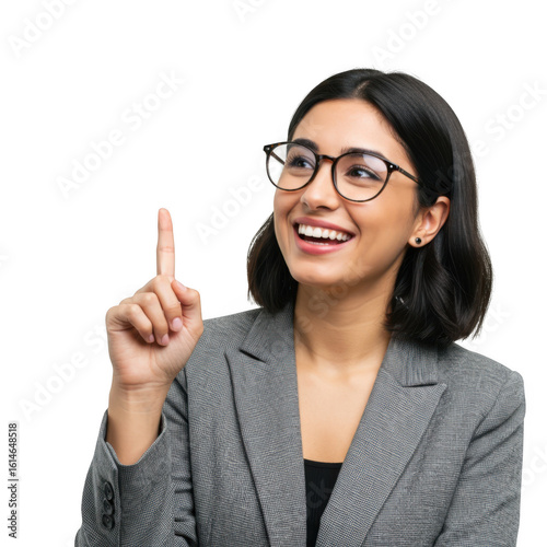 Smiling young woman wearing glasses and a grey blazer points her index finger upwards isolated on transparent background